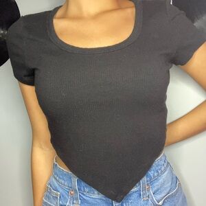Black scoop neck crop top tee , that comes to a v at the bottom. Stretchy.